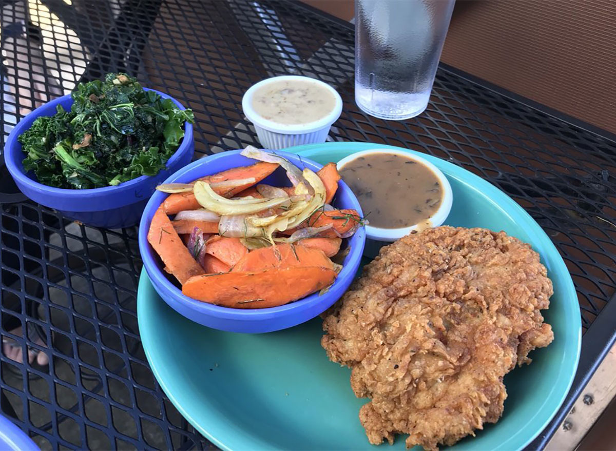 plate of fried chicken with vegetables and gravy