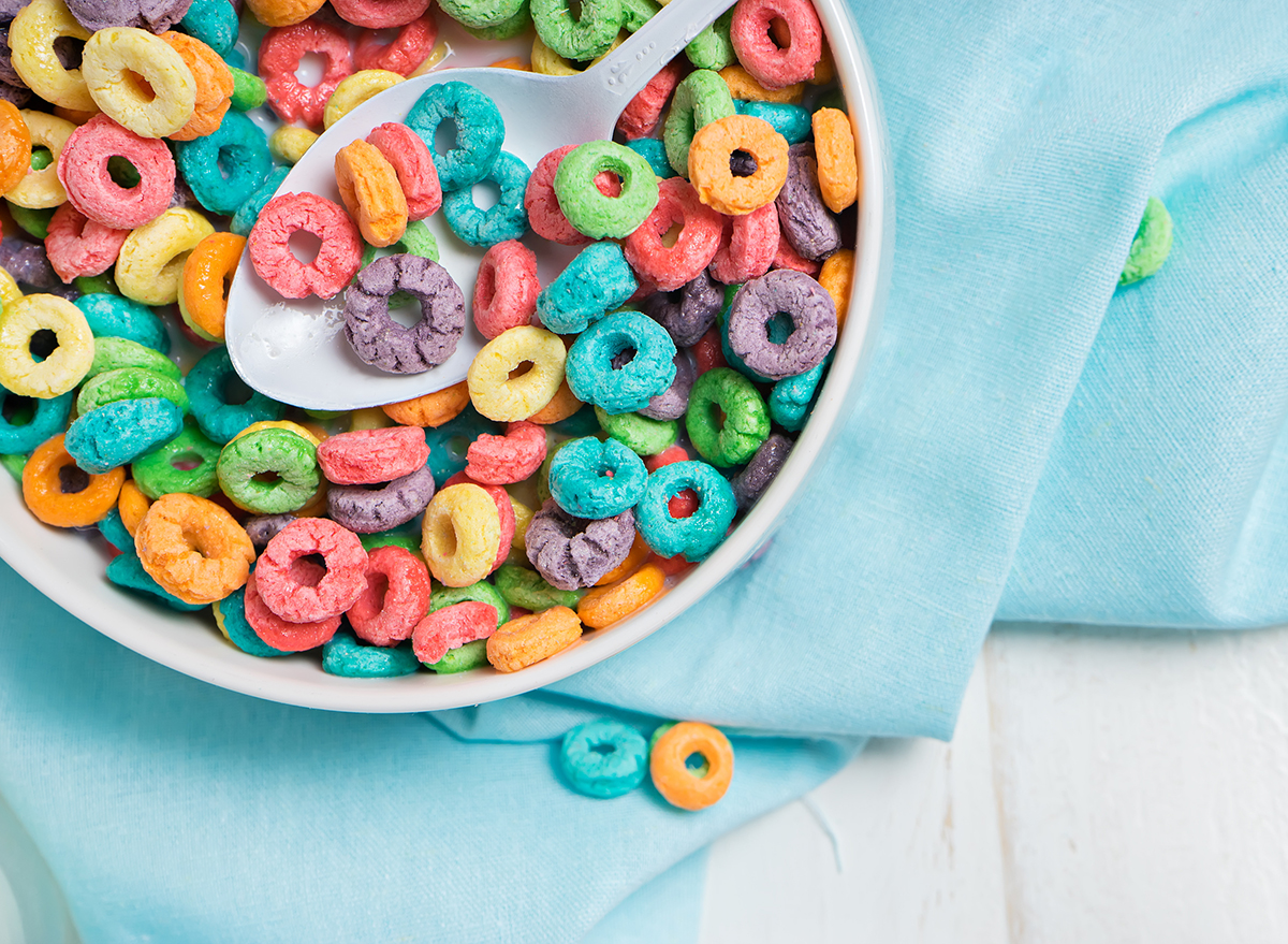 colorful sugary kids cereal in white bowl on blue towel