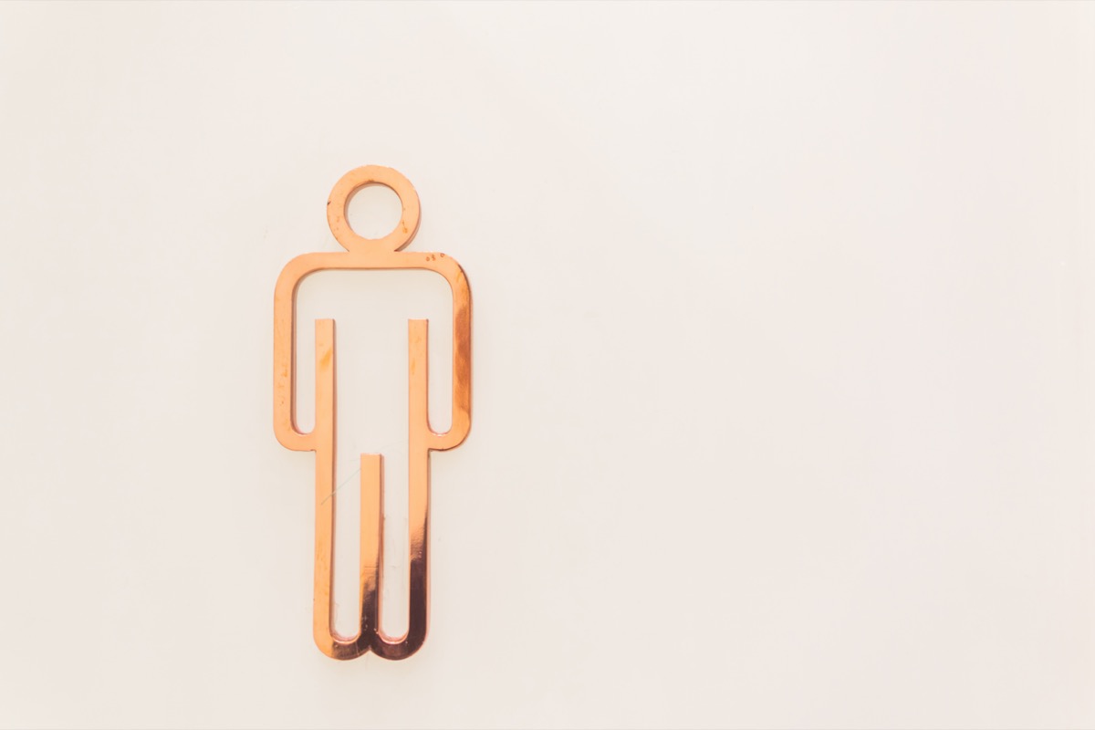 Men toilet signs on a white wall