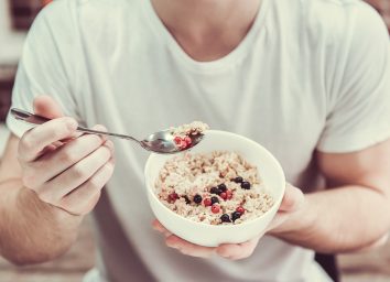 man holding bowl of oatmeal