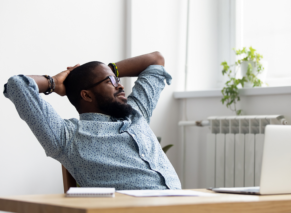 man sitting at desk looking out window