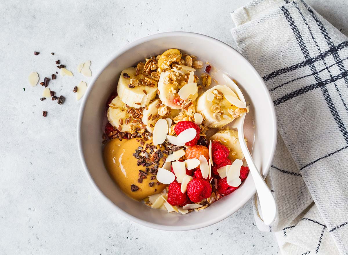 bowl of oatmeal with nut butter fruit and chocolate chips