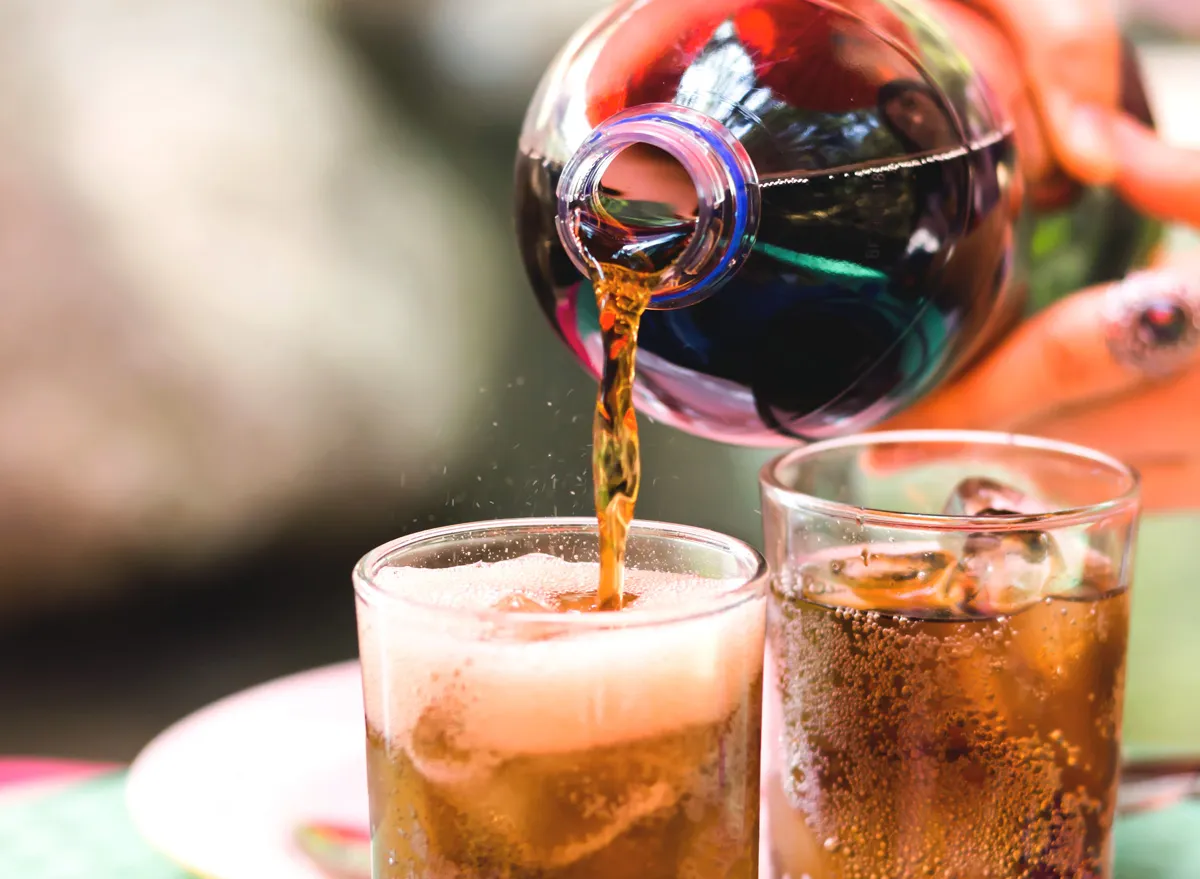 pouring coke soda into glass