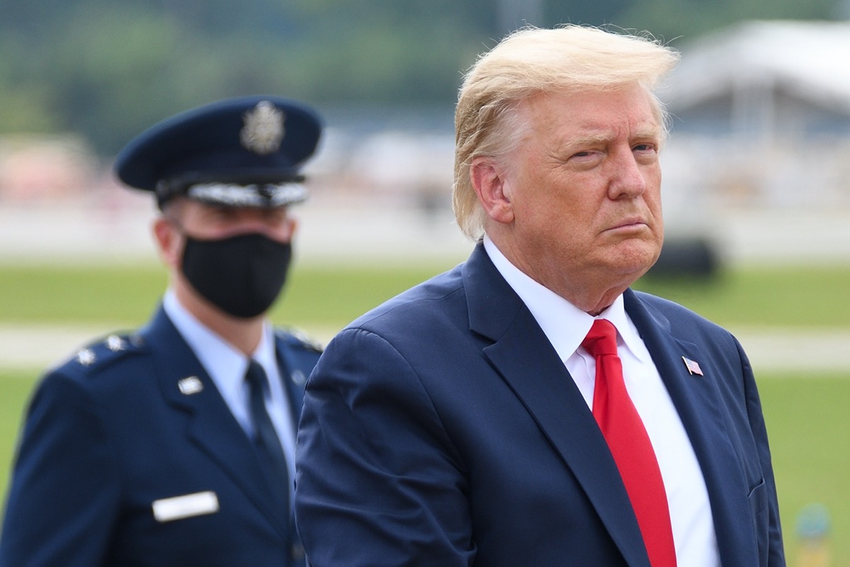 President Donald Trump walks to "The Beast" limousine with Air Force Major General John