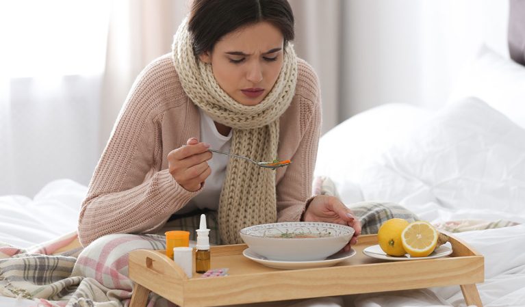 sick woman eating soup