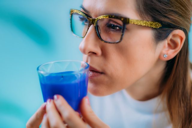 Woman Trying to Sense Smell of a Candle
