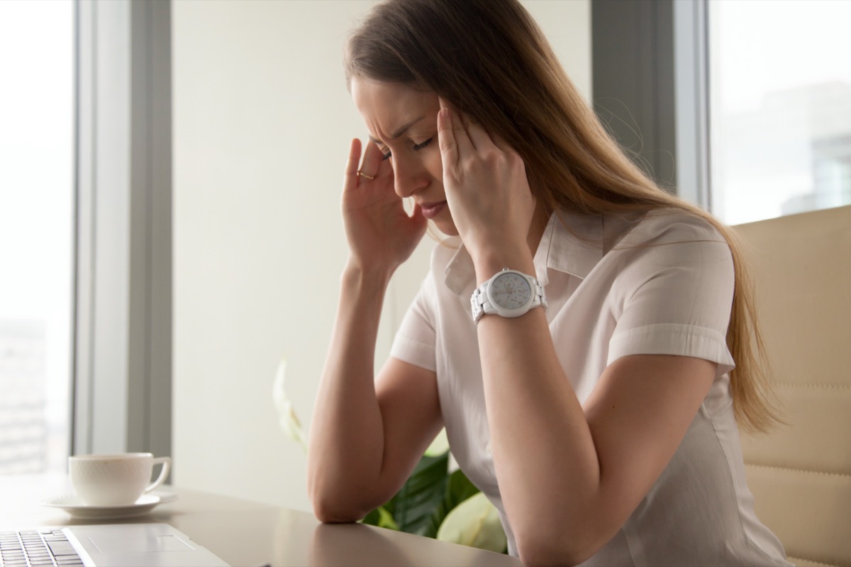 Businesswoman tries to cope with nervous tension or anxiety