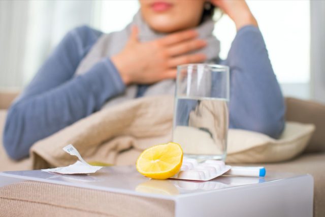 Sick woman and cold remedies.
