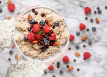 bowl of oatmeal with berries nuts and chocolate