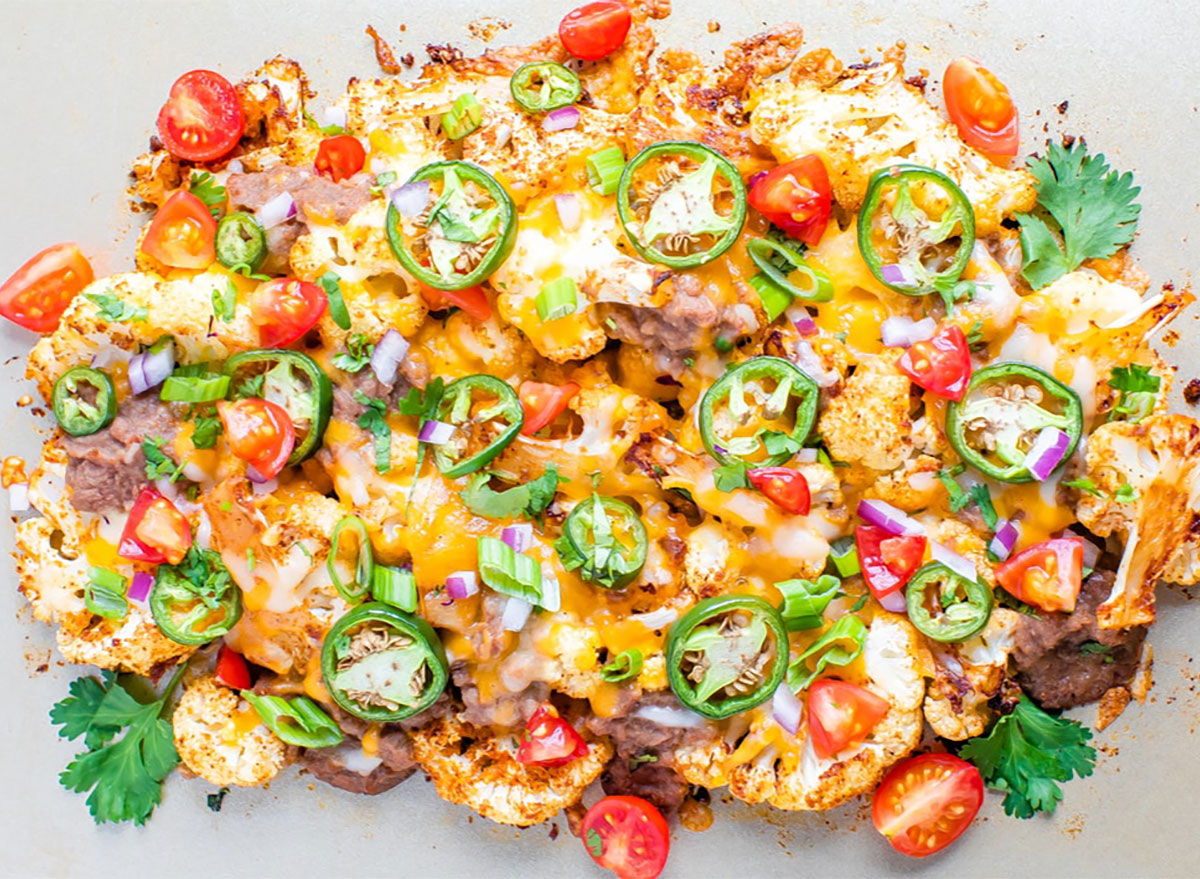 cheesy cauliflower nachos topped with jalapeno slices