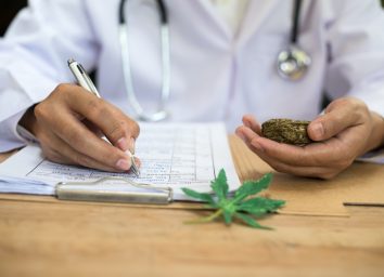 Doctor writing down marijuana research.