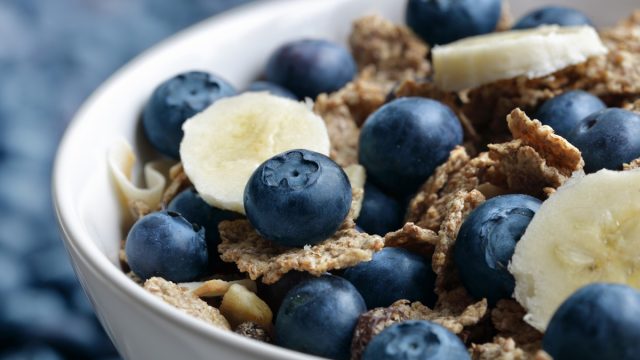 high fiber bowl of bran cereal with blueberries and bananas