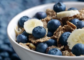 high fiber bowl of bran cereal with blueberries and bananas
