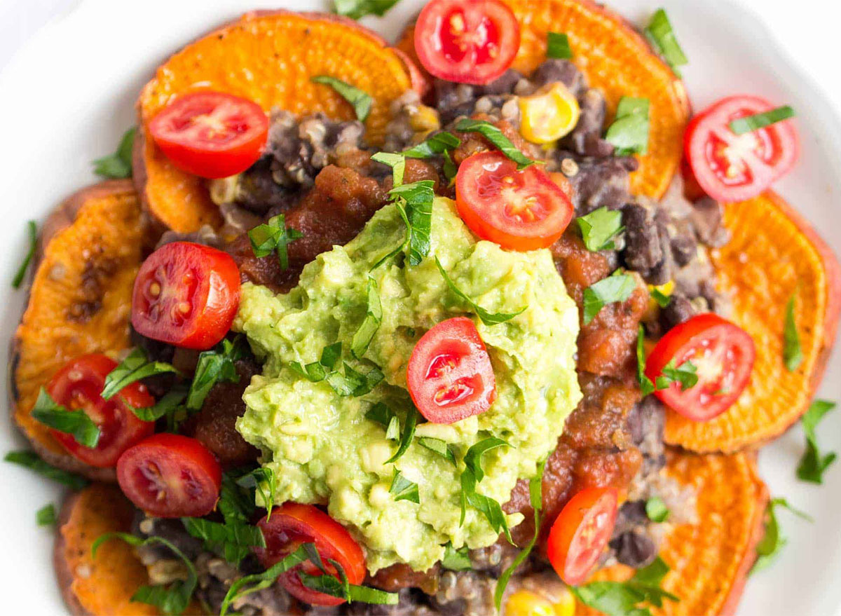 sweet potato slices topped with quinoa guacamole and tomatoes