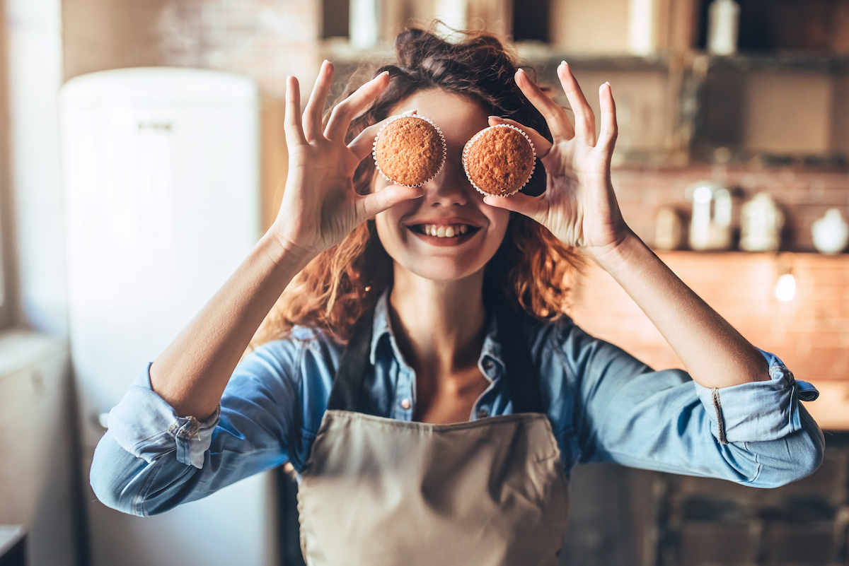 Happy and healthy woman baking muffins