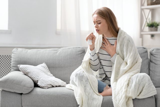 Woman coughing hardly at home