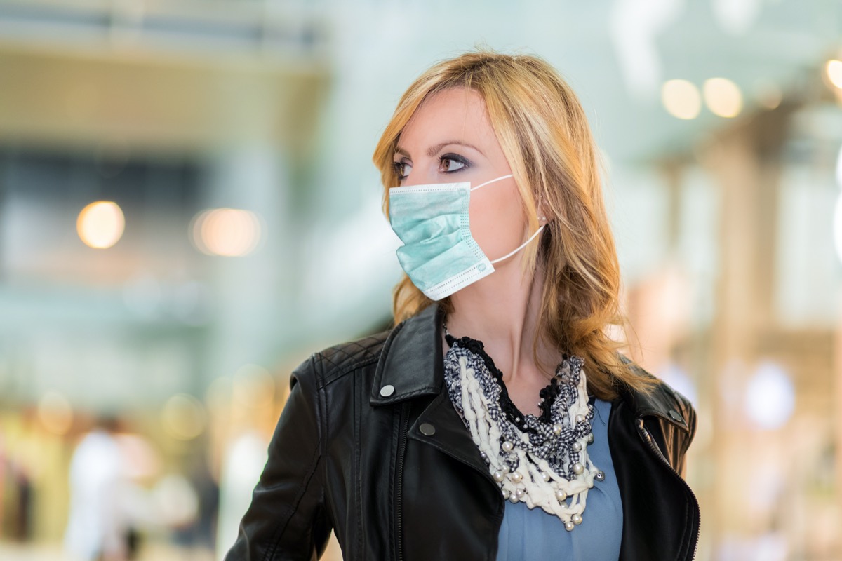 Portrait of blonde woman outdoor wearing a mask