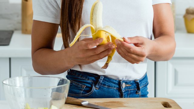 Woman peeling banana