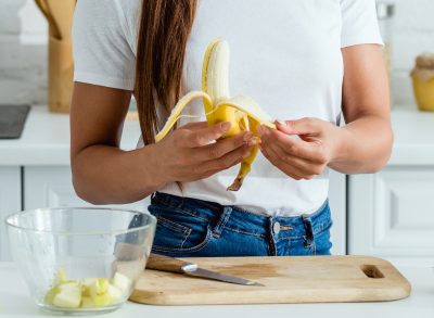 Woman peeling banana