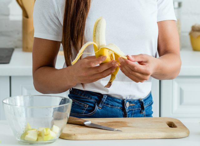 Woman peeling banana