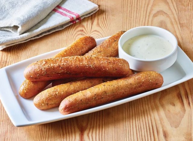 three breadsticks with alfredo sauce 