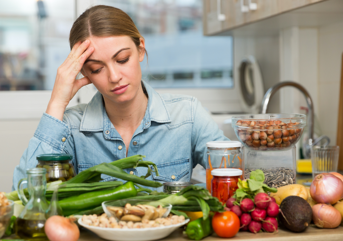 annoyed chef surrounded by food