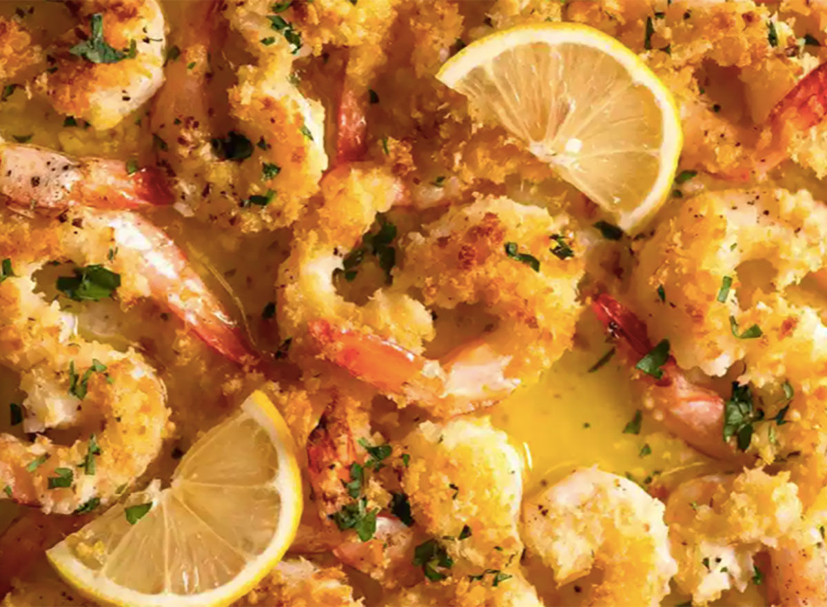 tray of baked breaded shrimp with lemon wedges