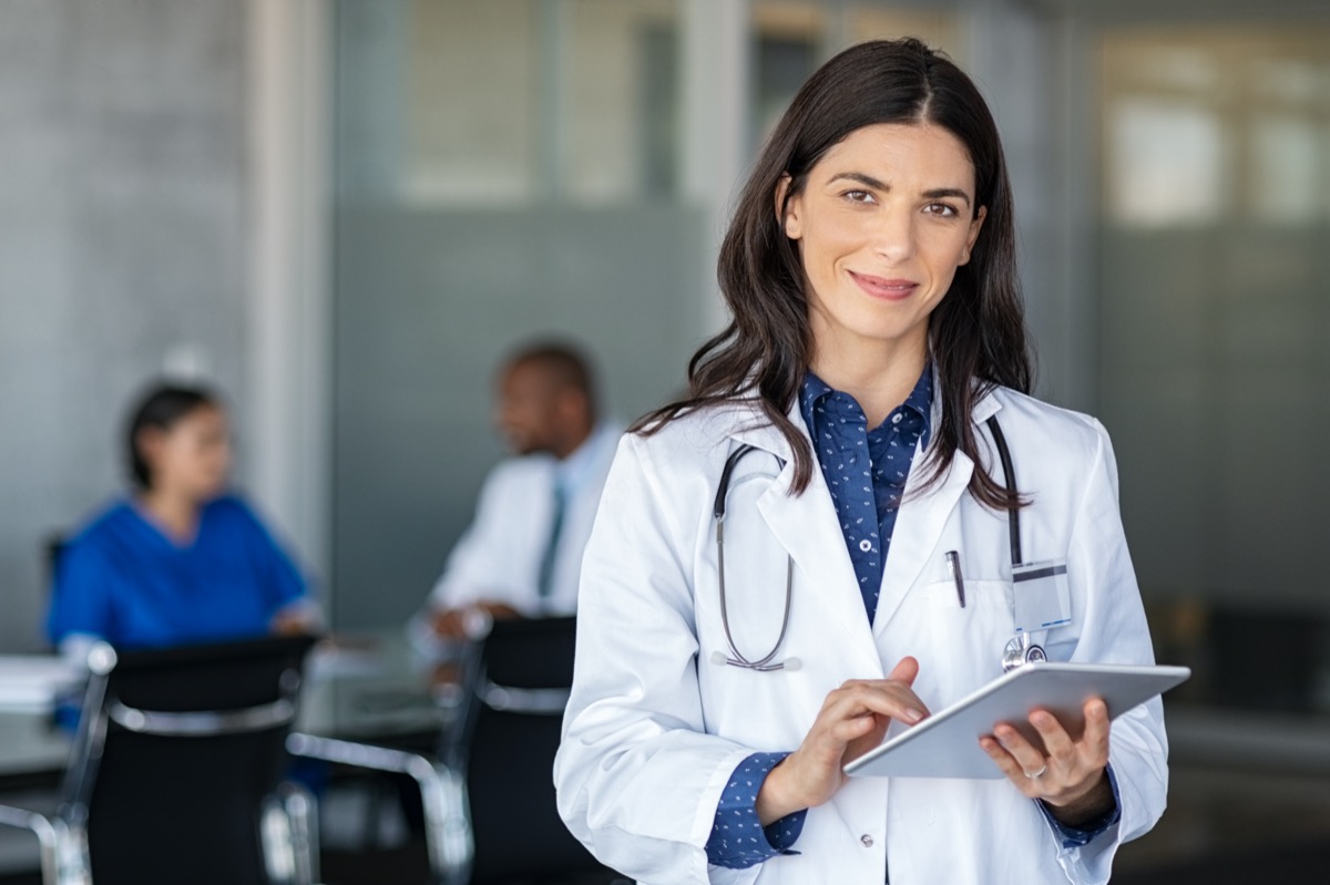 Doctor holding digital tablet at meeting room. 