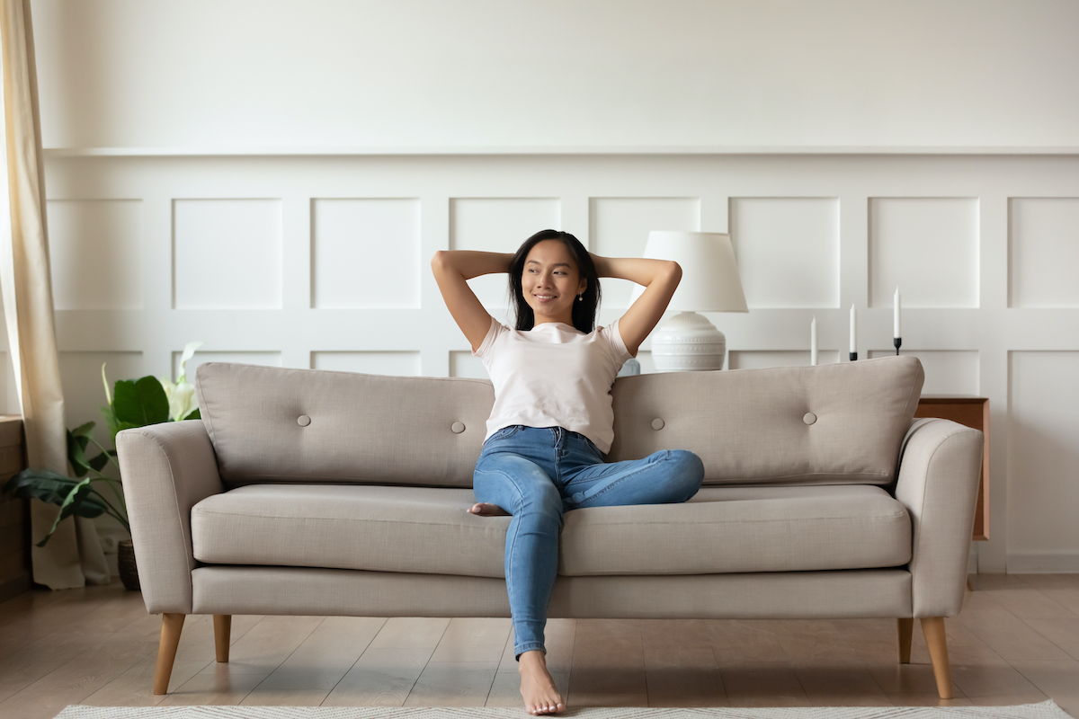 Happy woman sitting on a couch