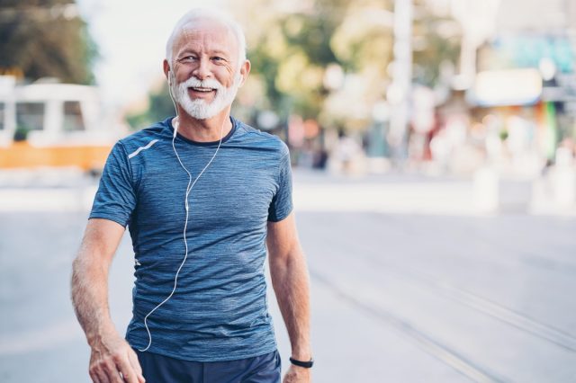 Senior athlete walking outdoors in the city