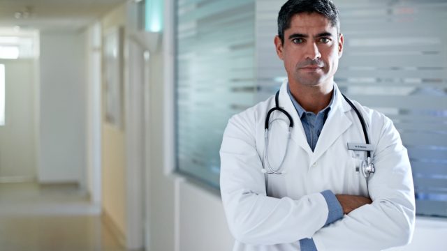 Doctor standing in a hospital corridor.