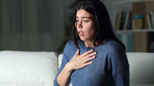 Woman suffering an anxiety attack alone in the night