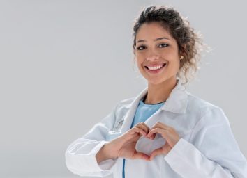Happy doctor making a heart shape and smiling