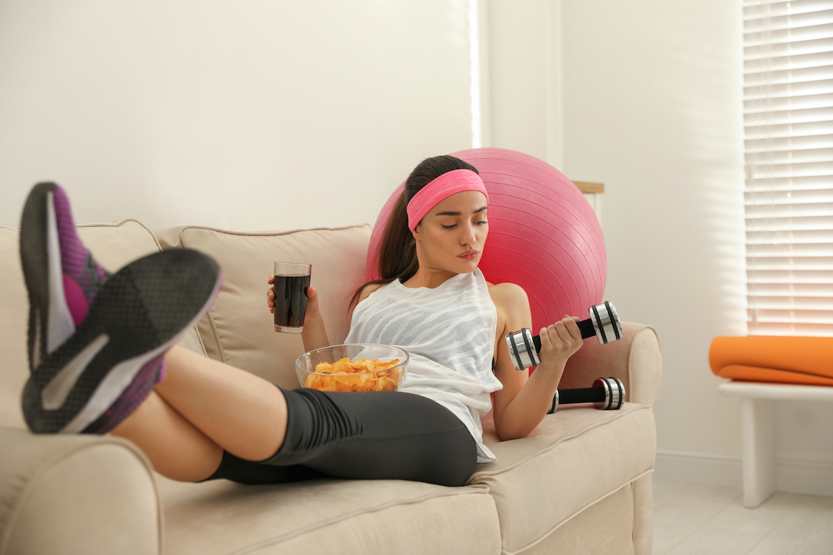 woman drinking a soda before exercise