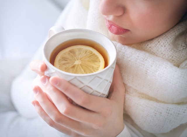 woman drinking tea and lemon