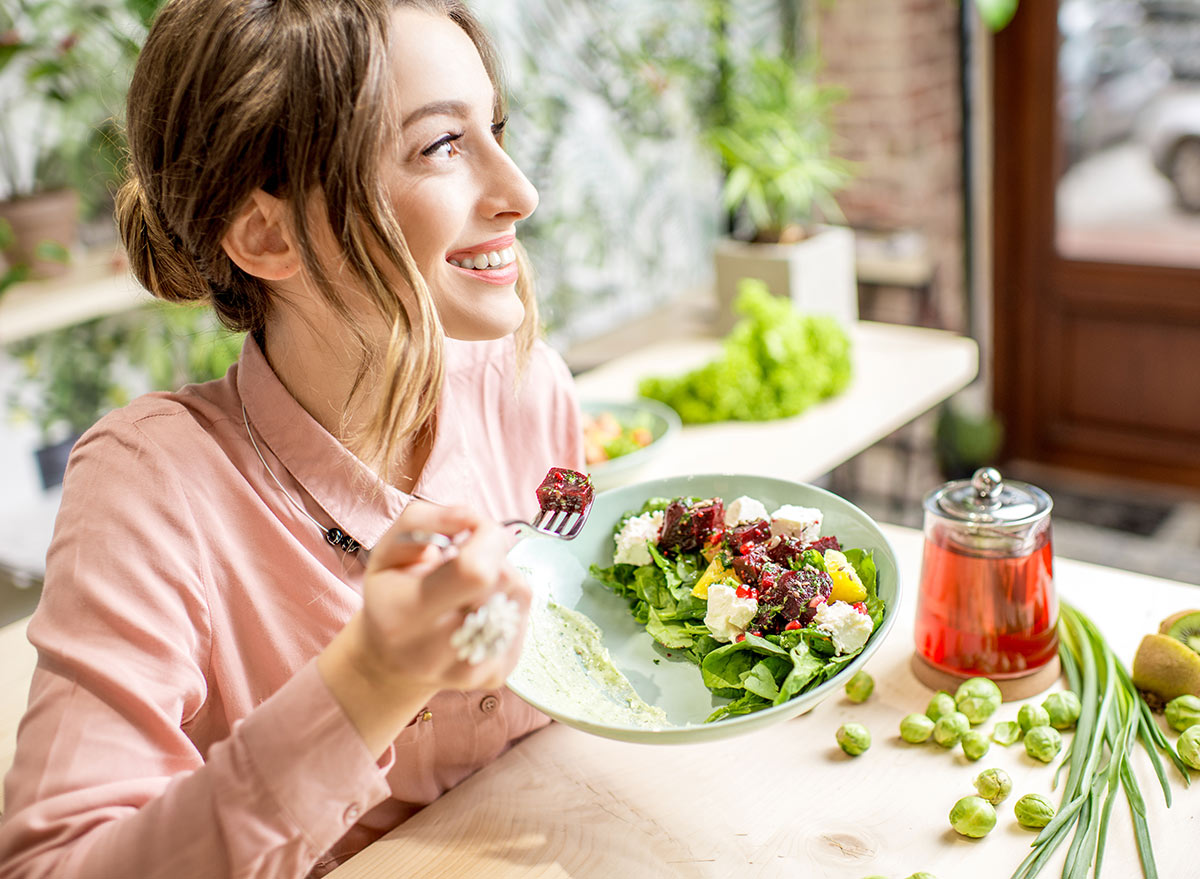 happy woman eating a healthy meal