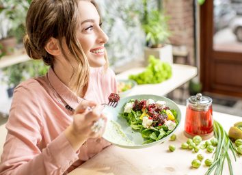 happy woman eating a healthy meal