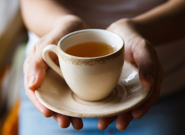 woman holding tea cup in hands