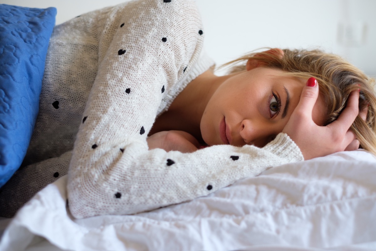 Woman feeling bad and trying to sleep