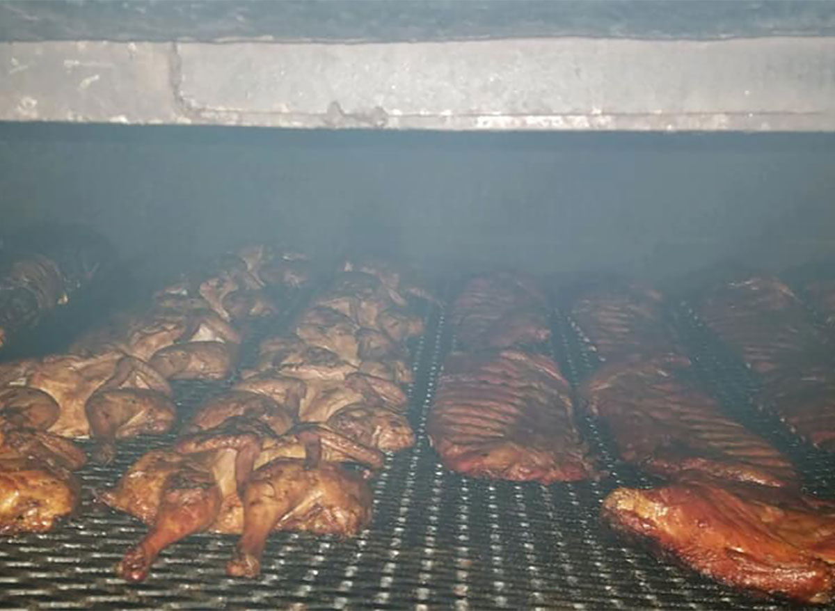 chicken and ribs in a smoker