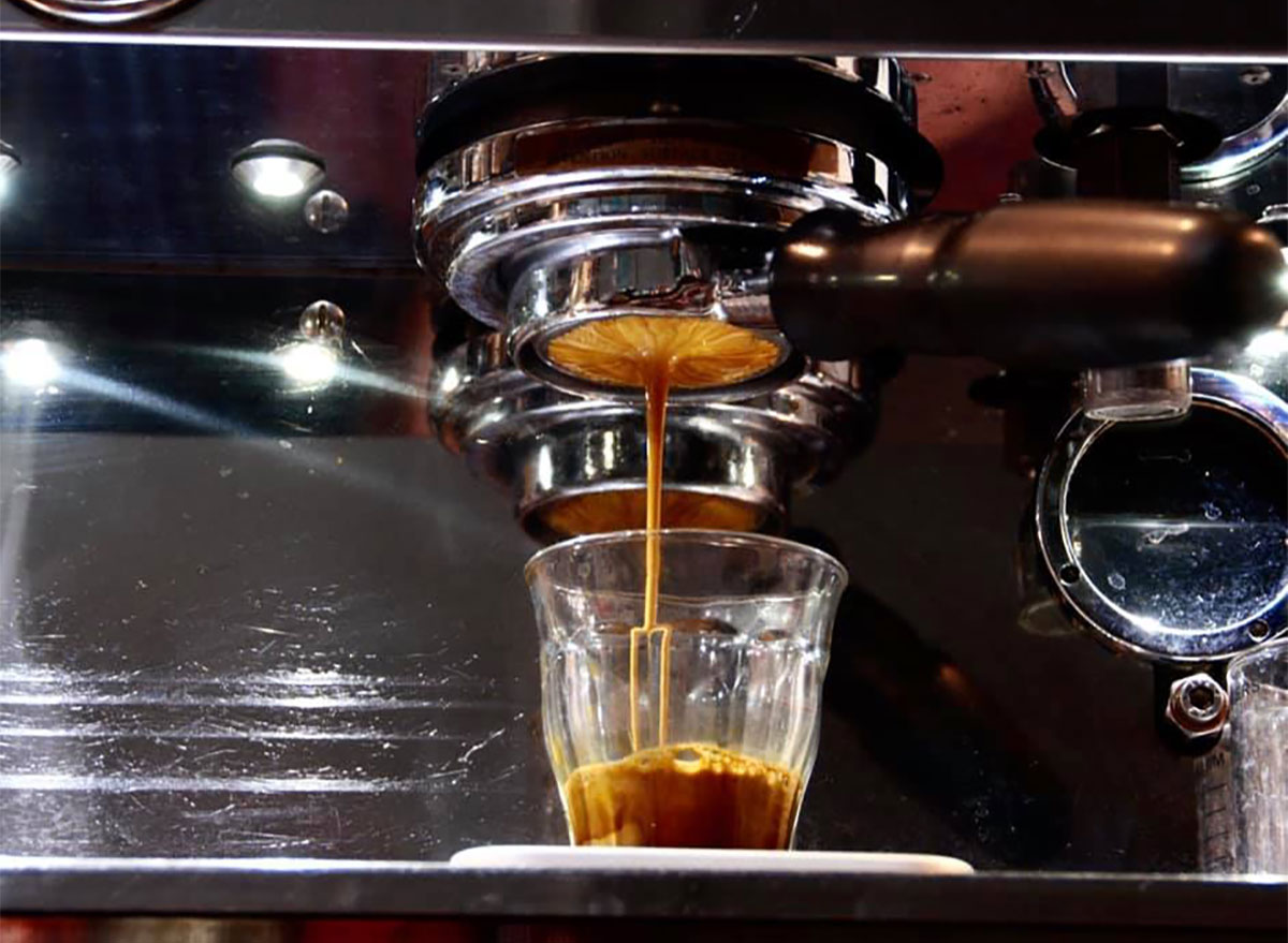espresso being poured into a glass cup