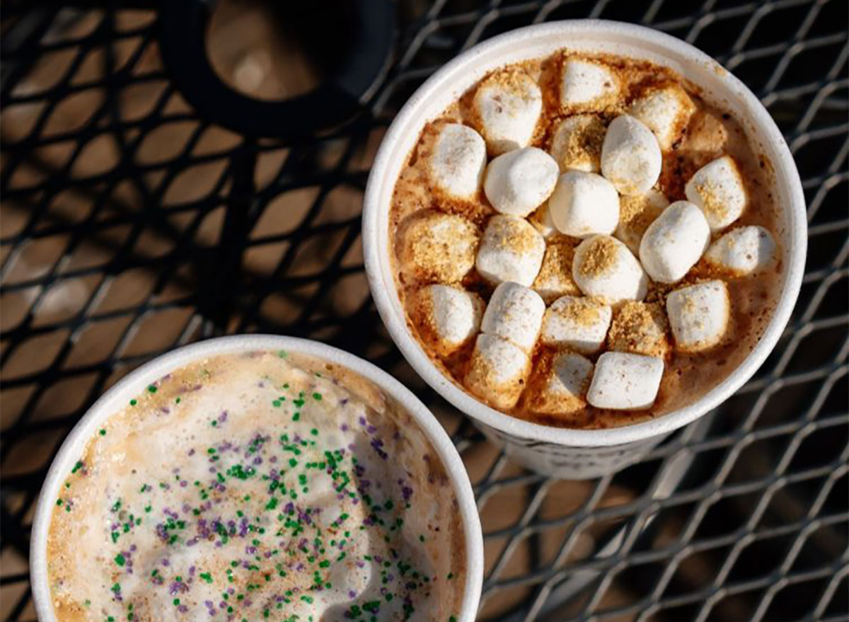 two specialty lattes in paper cups