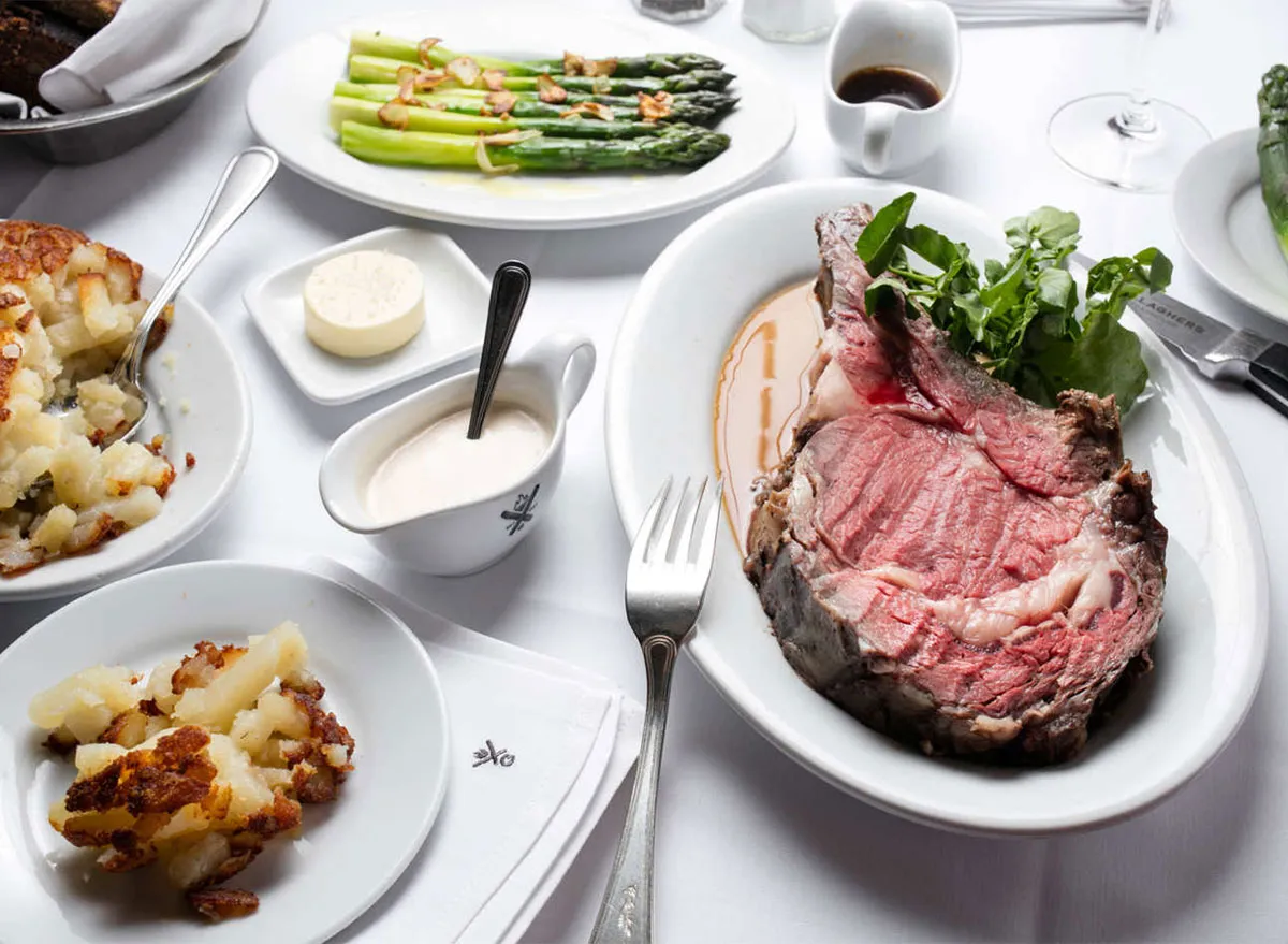 prime rib potatoes and asparagus on table at restaurant