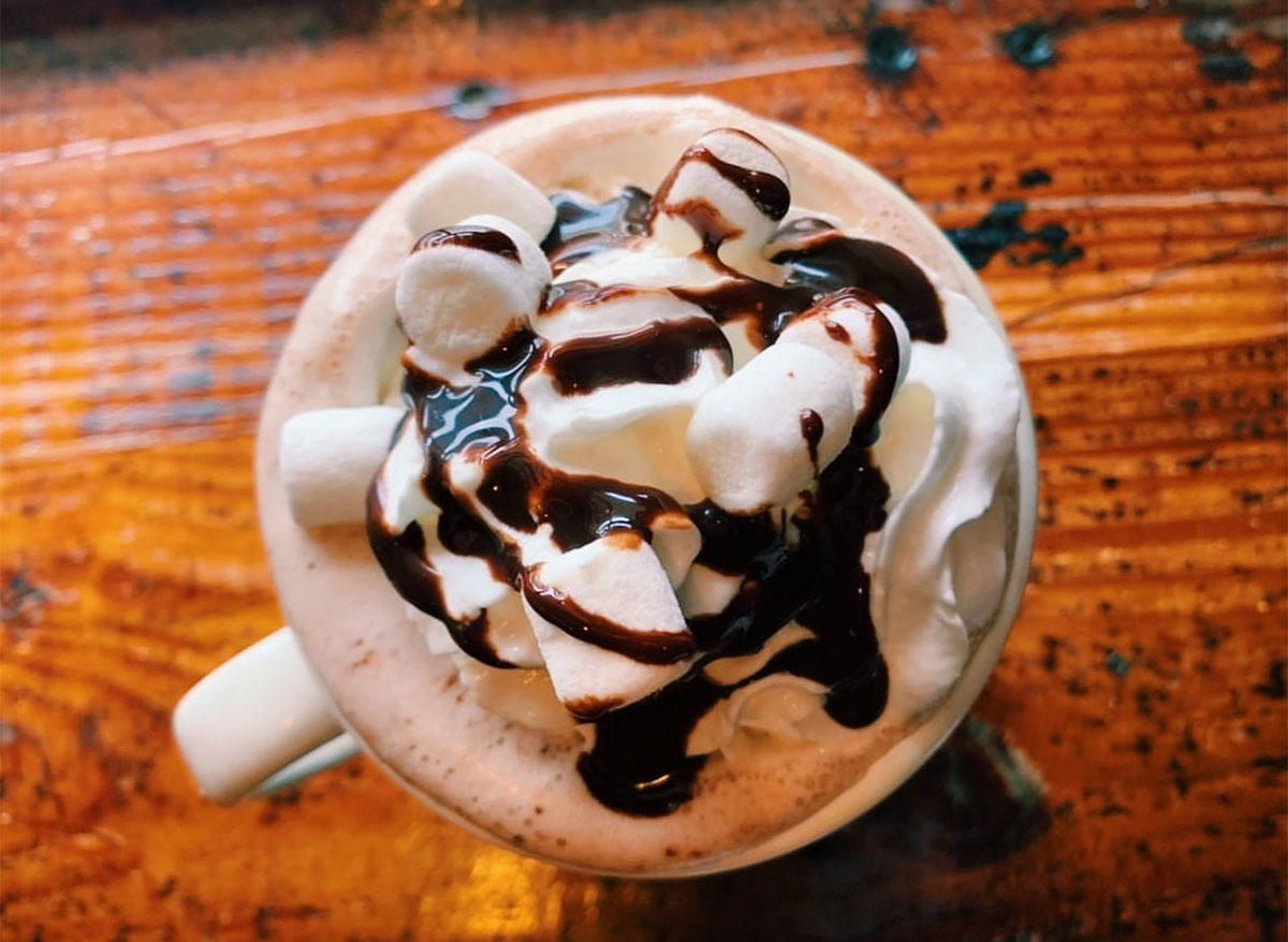 mug of hot chocolate topped with marshmallows and syrup