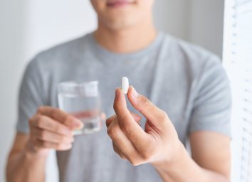 man holding pill