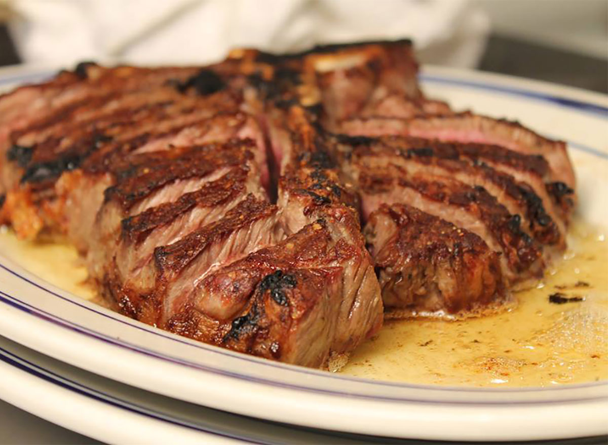 sliced steak with melted butter on white plate