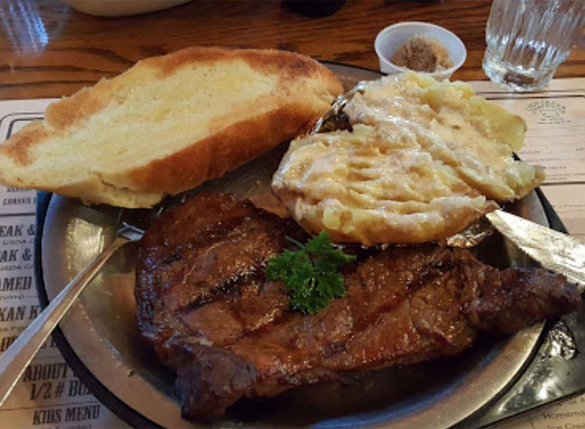 plated steak with bread and mashed potatoes