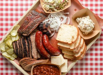 tray of texas barbecue with bread brisket hot links
