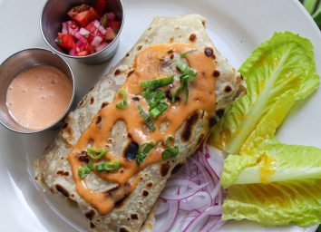 new orleans roll with lettuce and dipping sauce