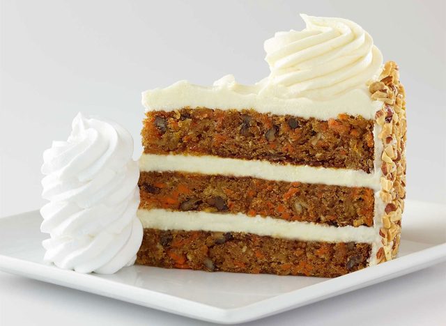 slice of carrot cake with frosting and whipped cream